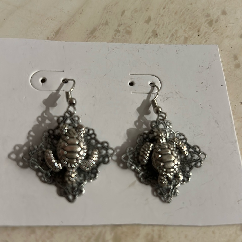 pierced earrings dangling silver tone design with turtle.